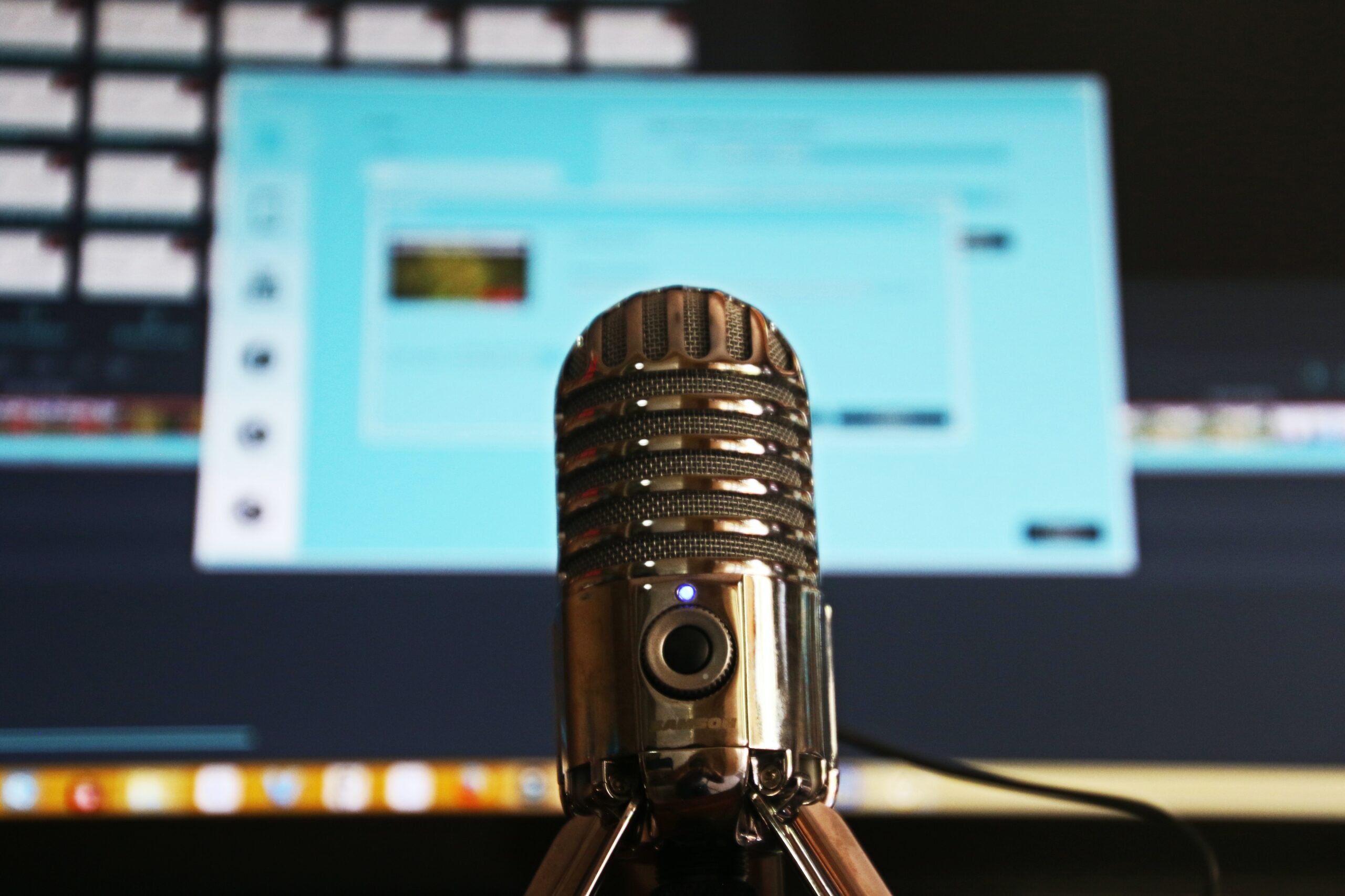 A photo of a microphone in front of a computer
